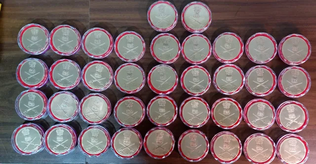 Rows of capsuled brass Indian Army coins