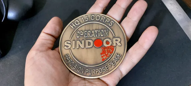 Operation Sindoor coin held in an open hand to show its size