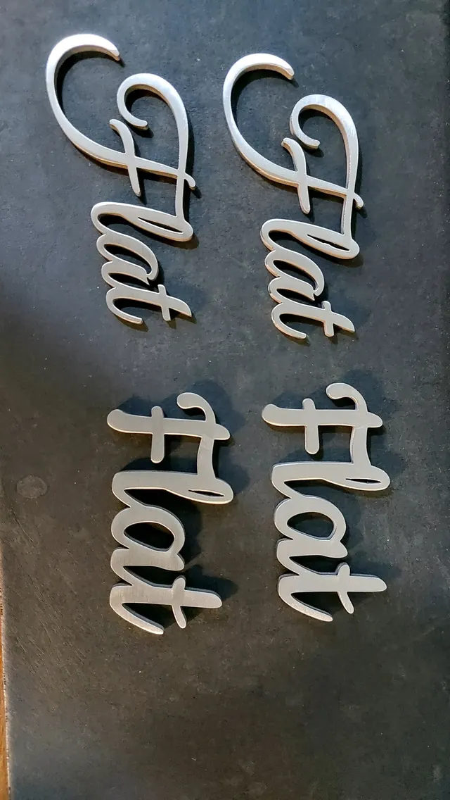 Laser-cut brushed steel script lettering