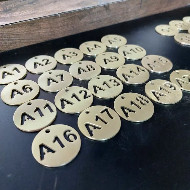 Brass numbered tags A1 to A20 with cut-through numbers and a hole for key rings